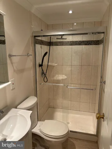 a bathroom with a toilet and a shower