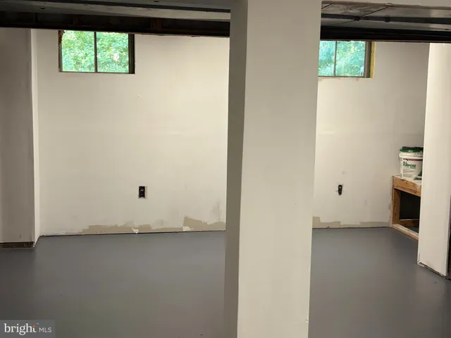 a view of a kitchen with wooden floor and windows