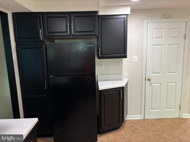 a refrigerator freezer sitting inside of a kitchen
