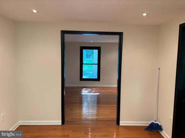a view of a hallway with wooden floor and a hallway
