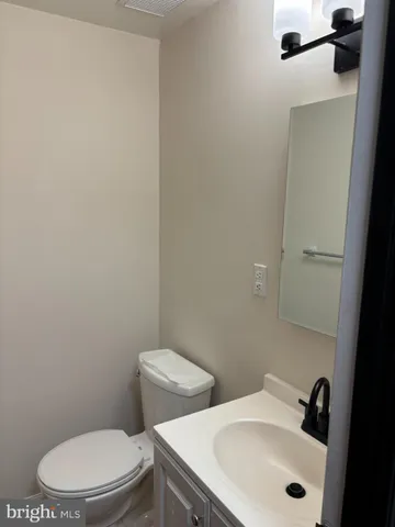 a white toilet sitting next to a bathroom sink