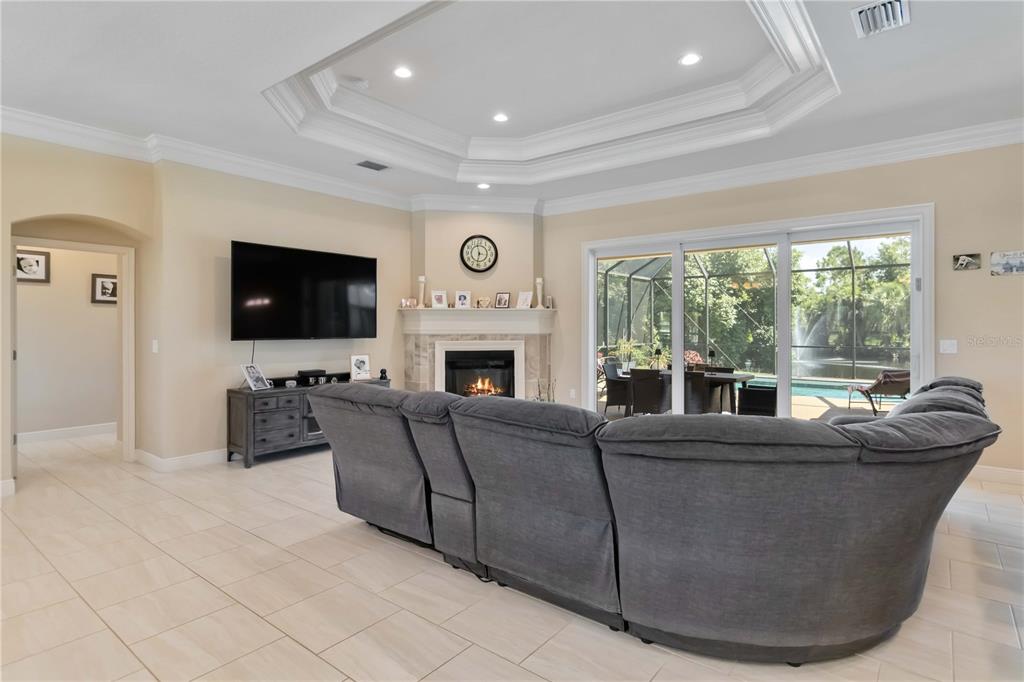 1991 Heasley Road Englewood, FL 34223 - Photo 15 of 70 a living room with furniture a flat screen tv and a fireplace