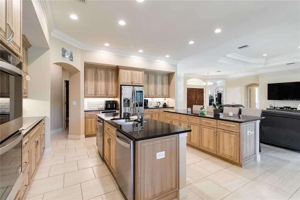 1991 Heasley Road Englewood, FL 34223 - Photo 20 of 70 a kitchen with stainless steel appliances granite countertop a sink stove and refrigerator