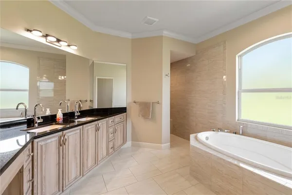 a bathroom with a granite countertop toilet a sink and shower