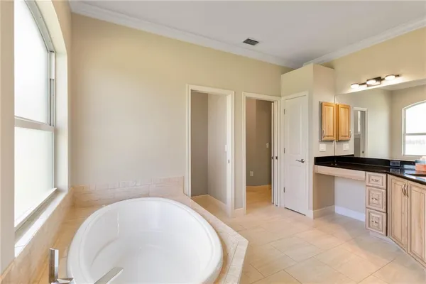 a bedroom with a bed couch and window