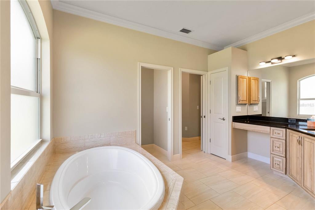 1991 Heasley Road Englewood, FL 34223 - Photo 26 of 70 a spacious bathroom with a bathtub and a sink