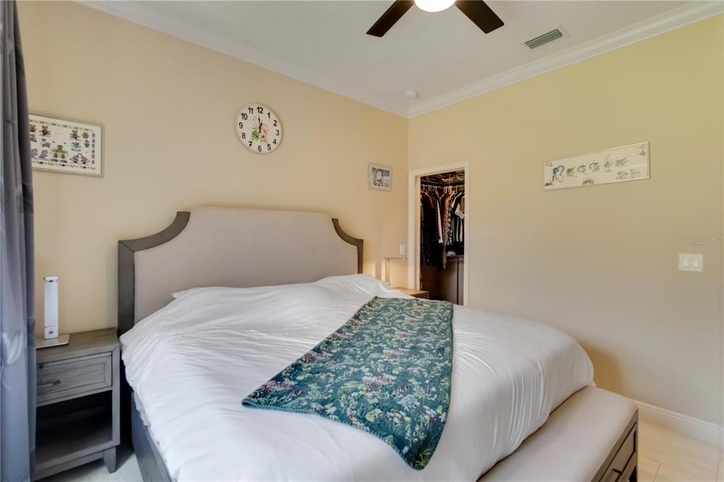 1991 Heasley Road Englewood, FL 34223 - Photo 35 of 70 a bedroom with a bed and a lamp on dresser