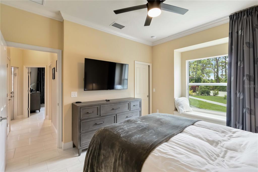 1991 Heasley Road Englewood, FL 34223 - Photo 38 of 70 a bedroom with a bed and a flat screen tv