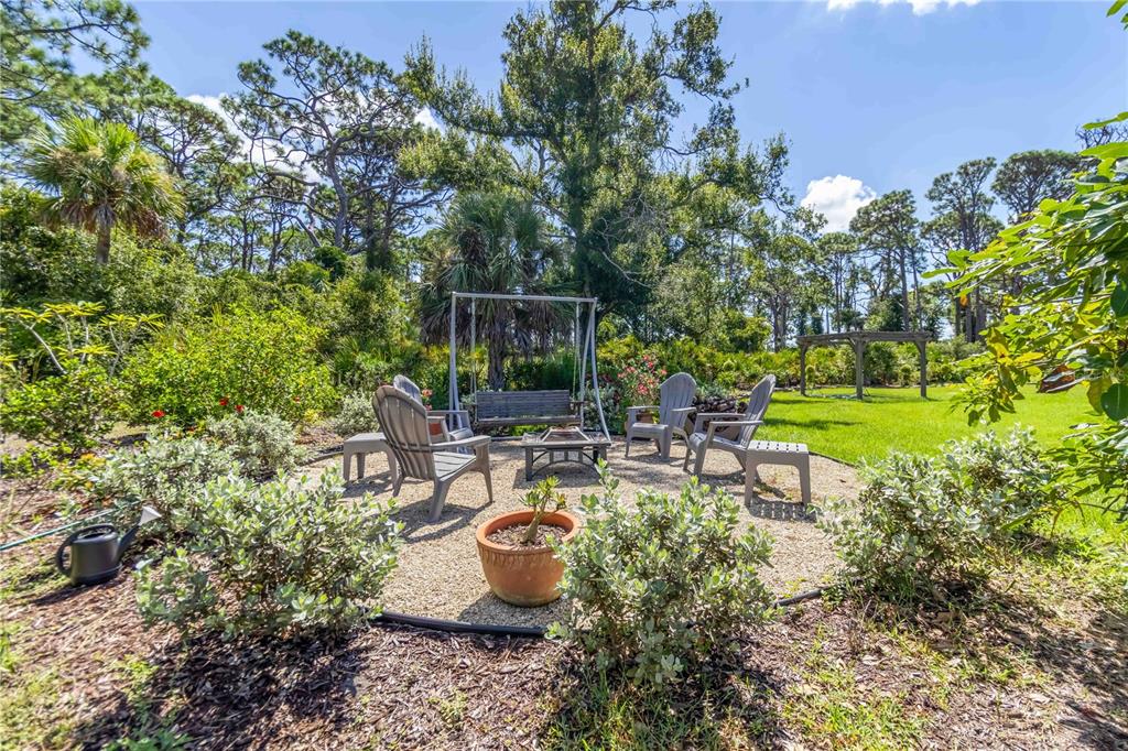 1991 Heasley Road Englewood, FL 34223 - Photo 54 of 70 a view of a backyard with sitting area and garden