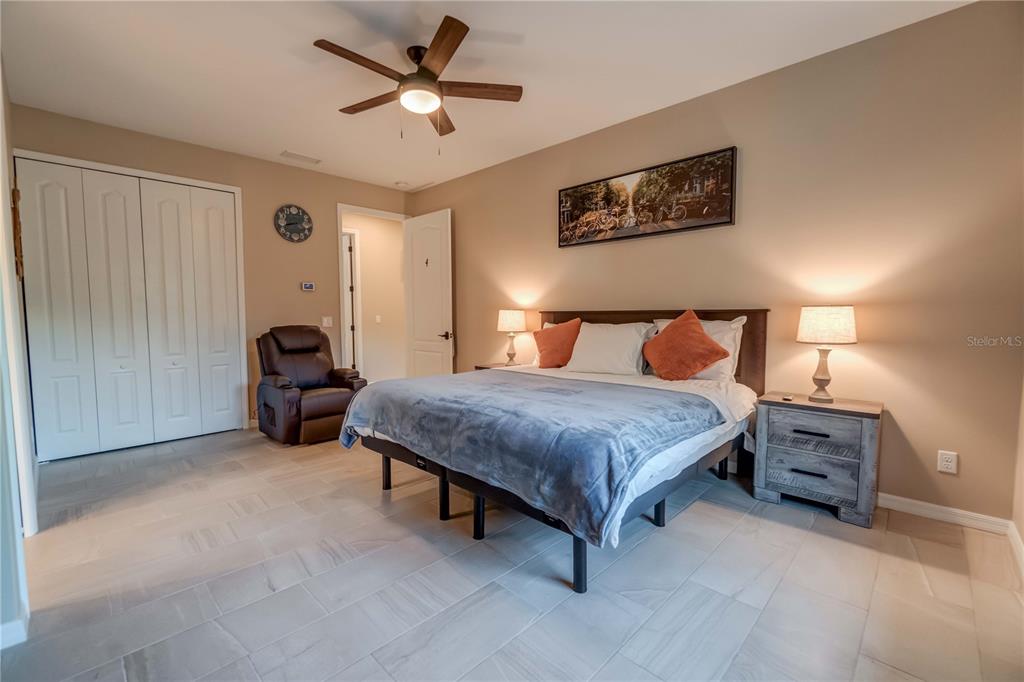 1991 Heasley Road Englewood, FL 34223 - Photo 62 of 70 a bedroom with a bed and a chandelier