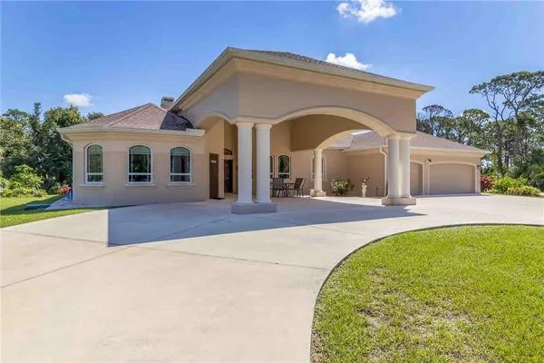 a large bathroom with a large mirror vanity and a bathtub