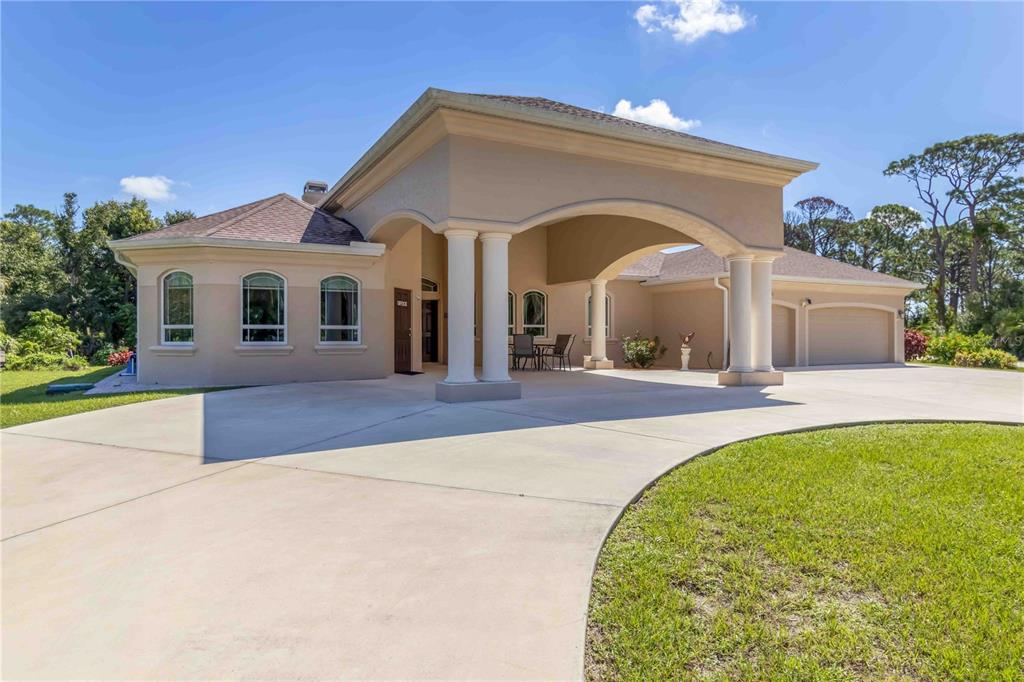 1991 Heasley Road Englewood, FL 34223 - Photo 9 of 70 a front view of a house with a yard