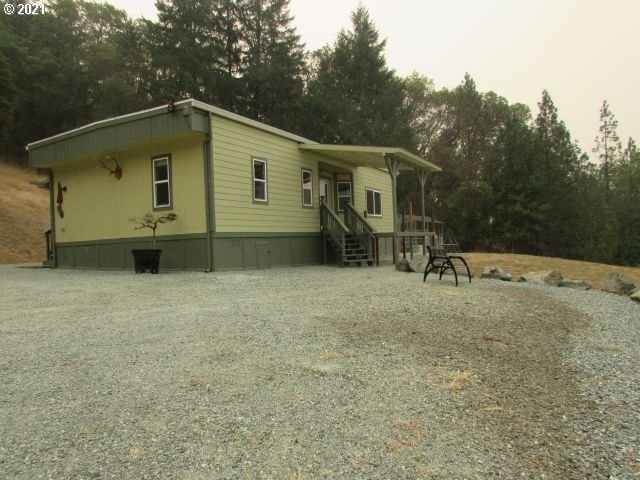 1073 Spring Brook Road Myrtle Creek, OR 97457 - Photo 8 of 24 a backyard of a house with table and chairs