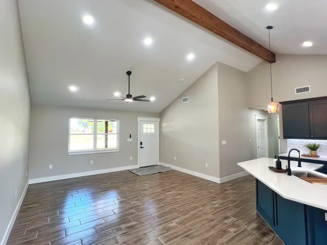 a large kitchen with kitchen island a sink stainless steel appliances and a window