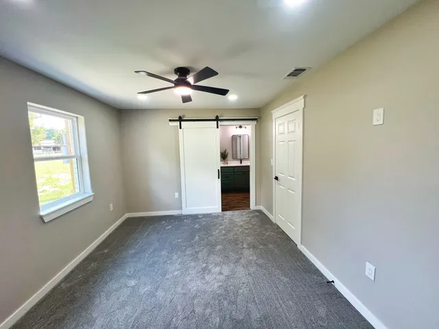 a view of an empty room with a window