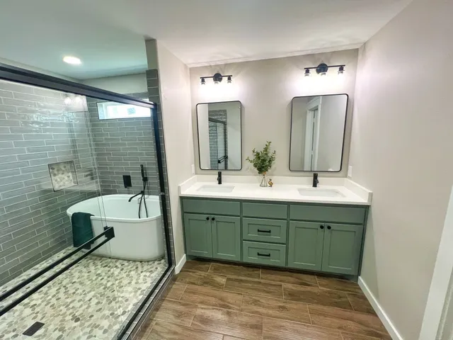 a bathroom with a double vanity sink mirror and toilet