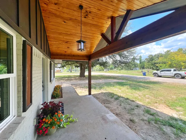 a view of a patio with swimming pool table and chairs