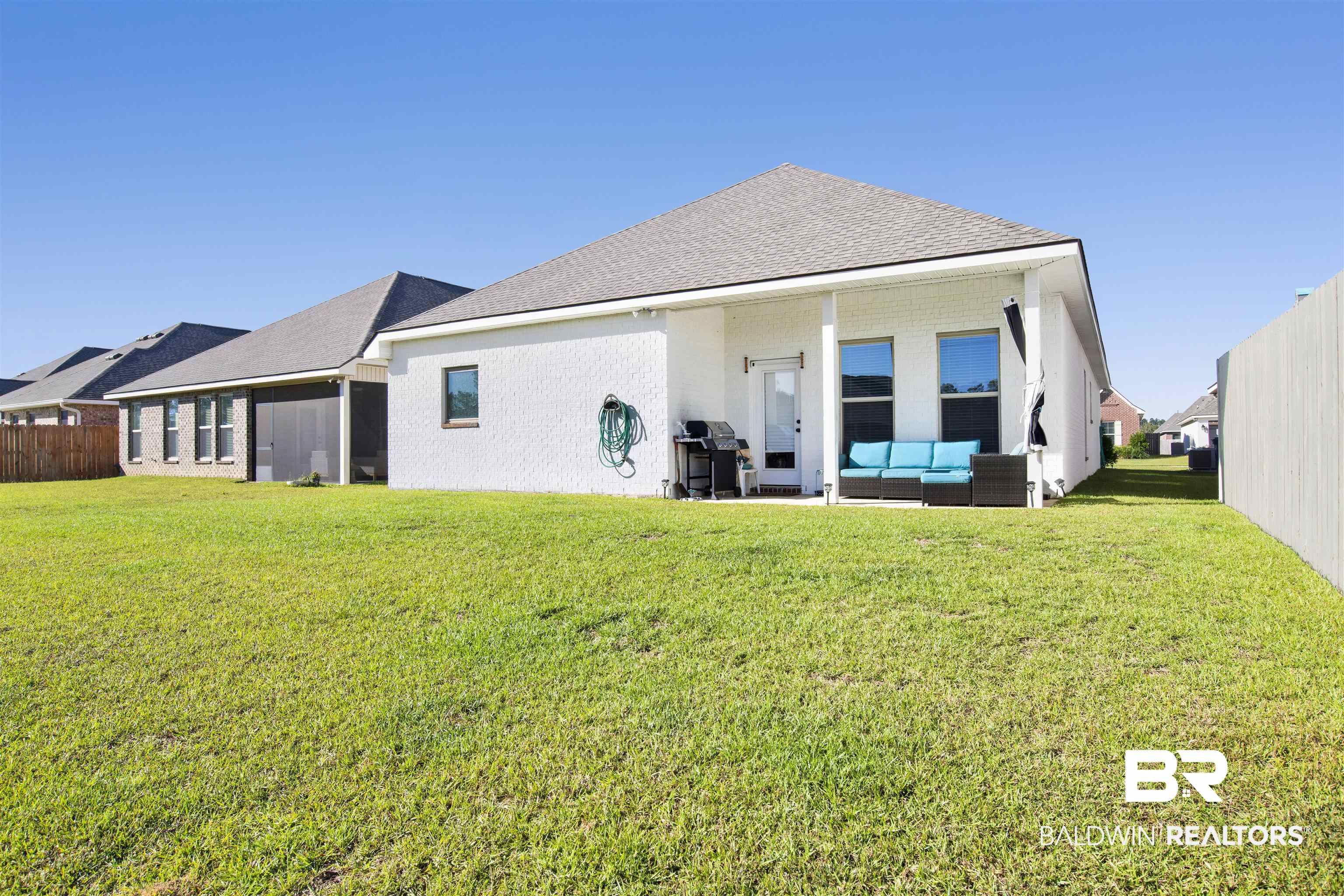 1406 Aldon Street Foley, AL 36535 - Photo 28 of 30 Back of house with an outdoor living space and a yard