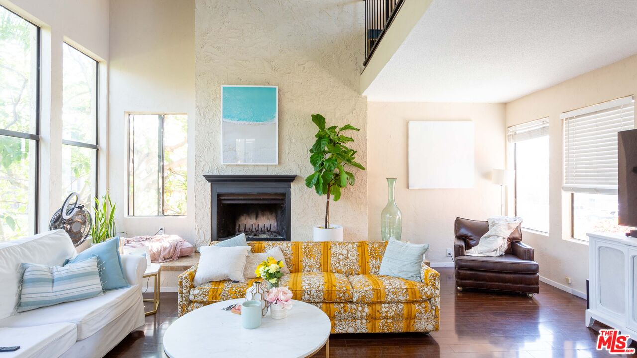 3809 Gran Corso Venice, CA 90292 - Photo 11 of 19 a living room with furniture fireplace and a large window