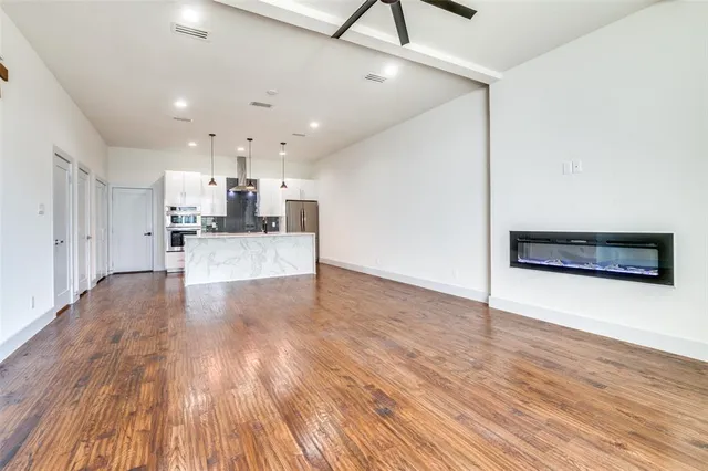 a view of large kitchen with wooden floor and electronic appliances