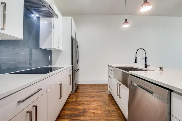 a kitchen with stainless steel appliances a sink and a stove