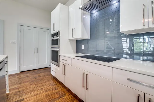 a kitchen with white cabinets and white appliances