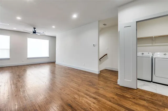 an empty room with wooden floor and a window