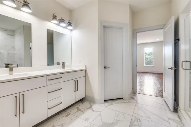 a bathroom with a double vanity sink and a mirror