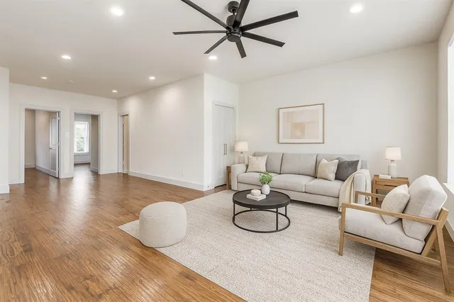 a living room with furniture and a wooden floor