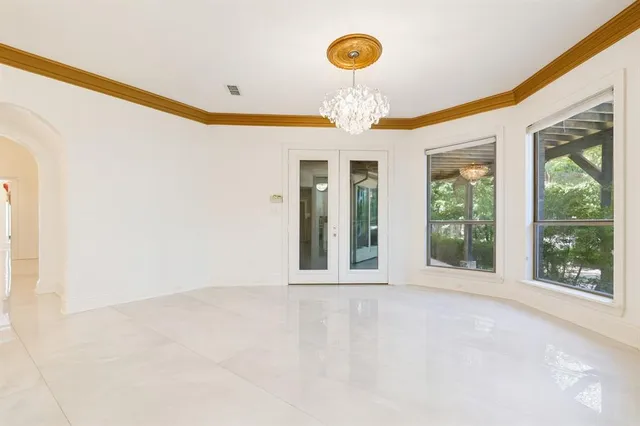 a large white kitchen with lots of counter space and a sink