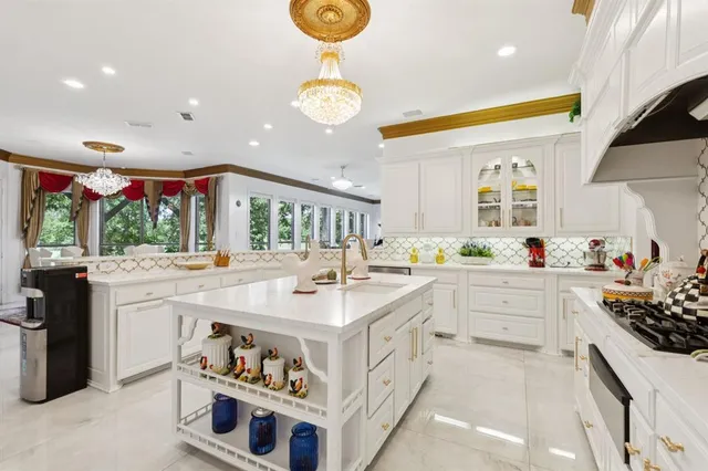 a large kitchen with a sink and dishwasher a stove with wooden floor
