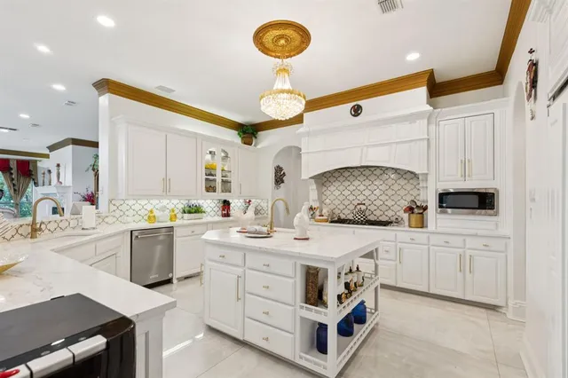 a living room with furniture kitchen view and a flat screen tv