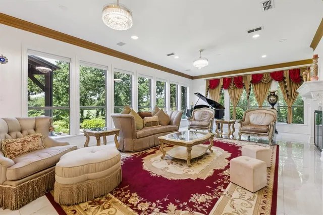 a living room with furniture a rug and a large window