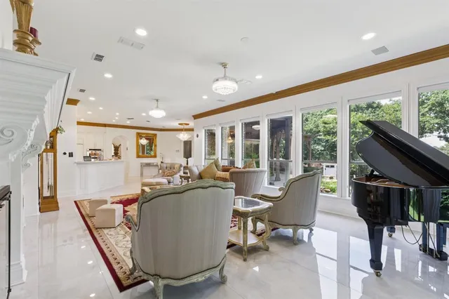 a living room with furniture and a chandelier