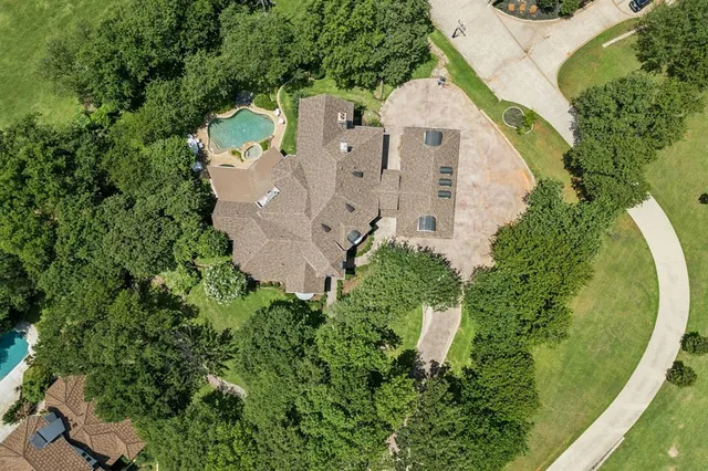 an aerial view of residential houses with outdoor space and swimming pool