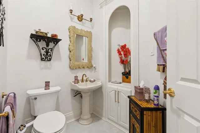 a bathroom with a sink a toilet and a mirror