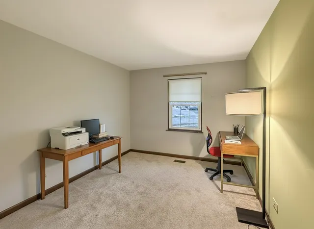a view of a room with a window and a workspace