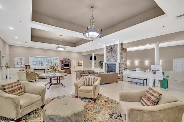 a living room with furniture a large window and chairs