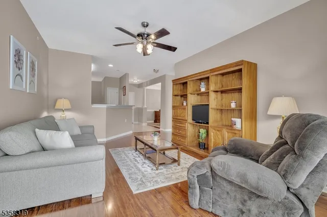 a kitchen with a refrigerator a stove and a wooden floor