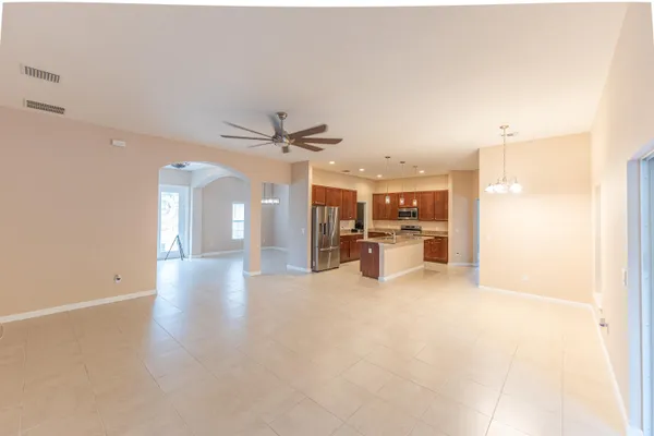 a view of a livingroom with a ceiling fan and entryway