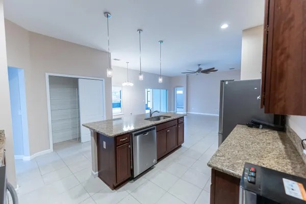 a kitchen with a stove sink and refrigerator