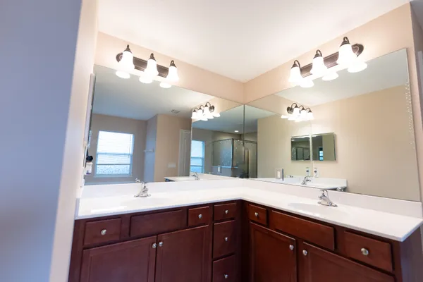 a bathroom with a sink vanity and a mirror