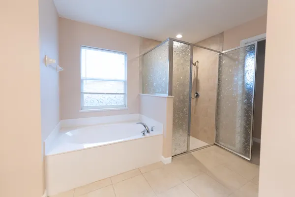 a spacious bathroom with a bathtub and a shower