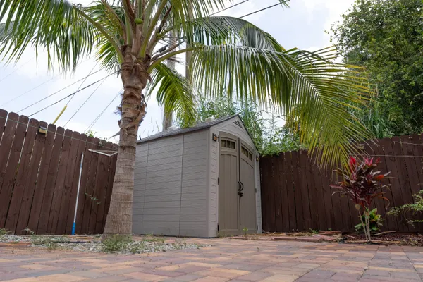 a couple of palm trees in front of a house