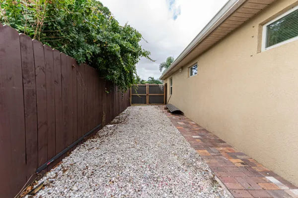 a view of a backyard with wooden fence