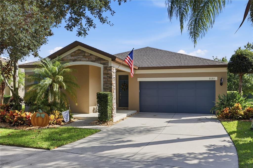7125 Beek Street Windermere, FL 34786 - Photo 1 of 1 a front view of a house with a yard and garage