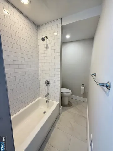 a bathroom with a bathtub and toilet