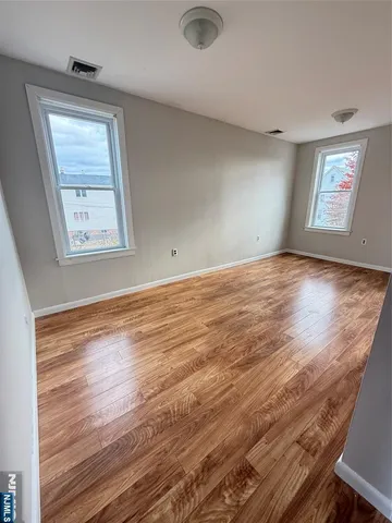 a spacious bedroom with a bed and a window