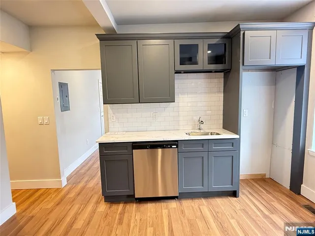 a view of kitchen with stainless steel appliances granite countertop a stove and a refrigerator