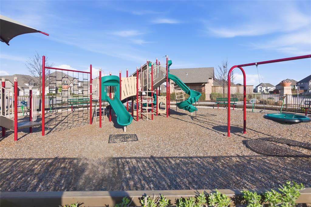 464 LeTara Ranch Drive Haslet, TX 76052 - Photo 35 of 37 Community playground featuring multiple slides, climbing structures, swings, and a protective ground covering